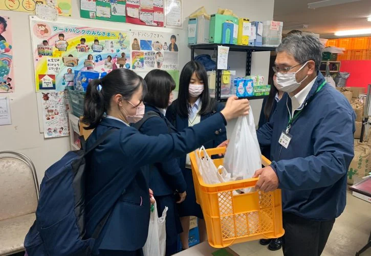 学生からの食品寄贈を受け取るスタッフ